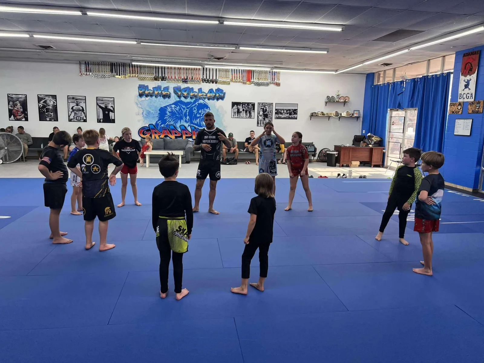 Kids Brazilian Jiu-Jitsu class training on the mats at Blue Collar Grappling Academy